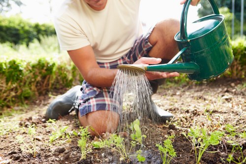 Company vehicle and crew preparing lawn mowing equipment